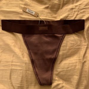 Skims Cotton Rib Thong in the color Garnet